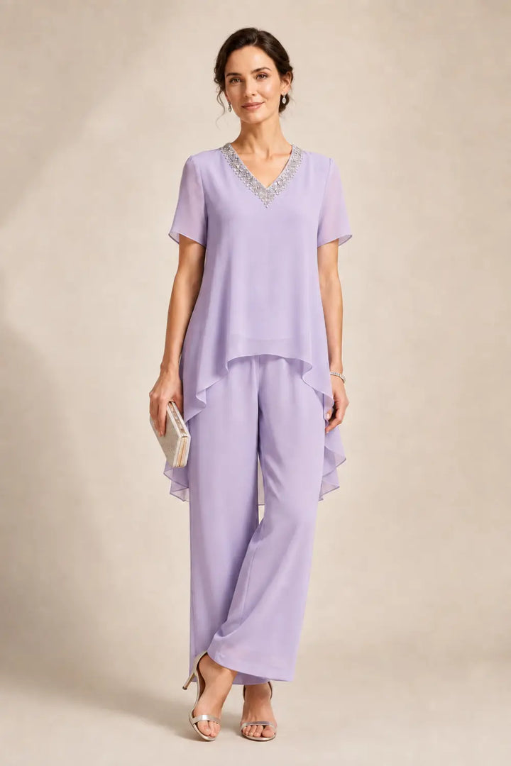 Tuta pantalone asimmetrica con mantella in chiffon e scollo a V